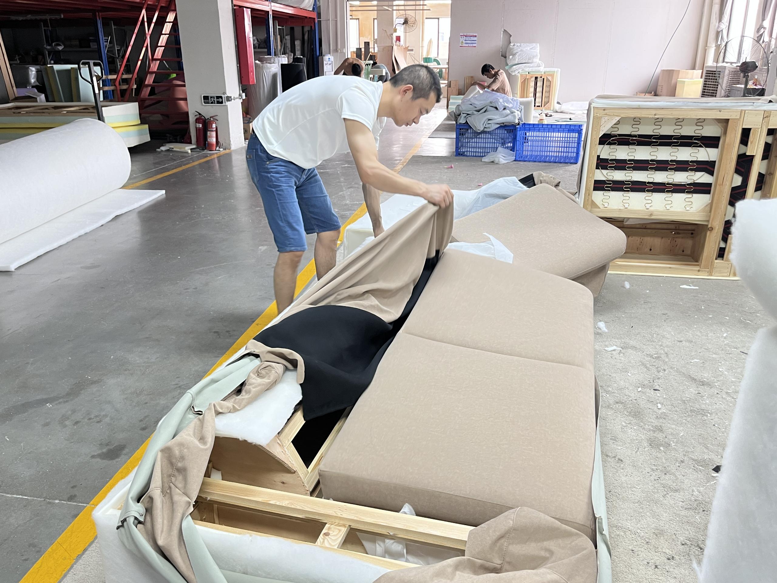 Upholstered furniture structure being reviewed inside a factory